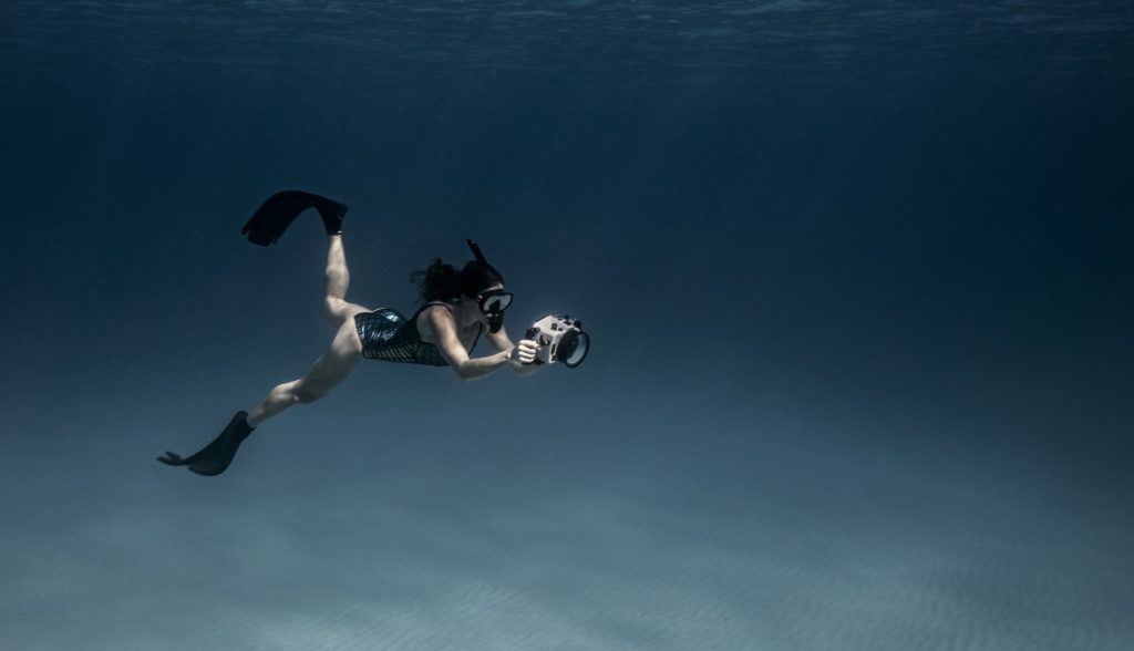 underwater view of female free diver with underwater camera bimini bahamas